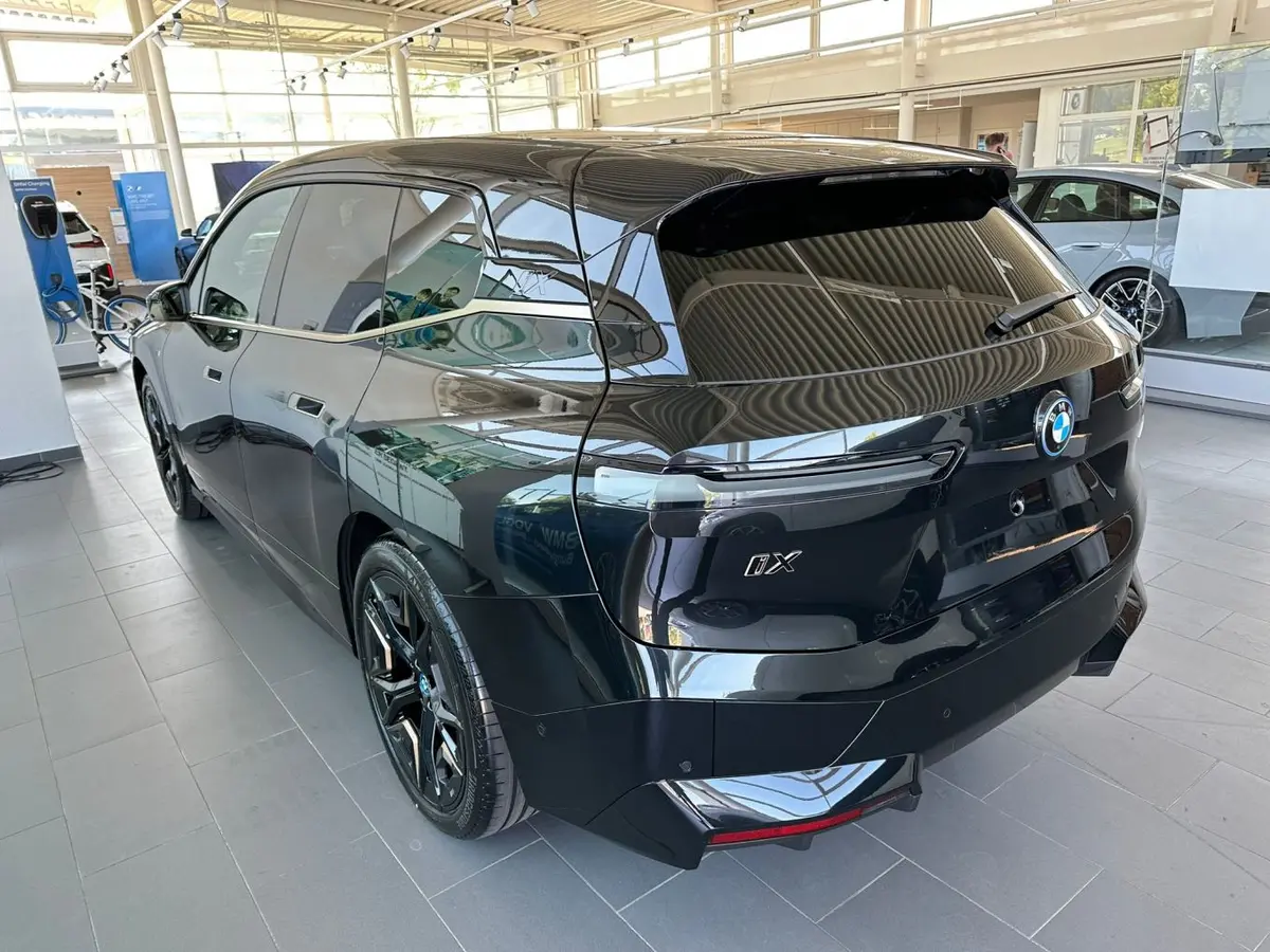 BMW IX M60 2023, rear view — Venice Lux Car Rental, Venice. The BMW iX M60 brings 619 hp into a fully electric SUV body, which means the usual…